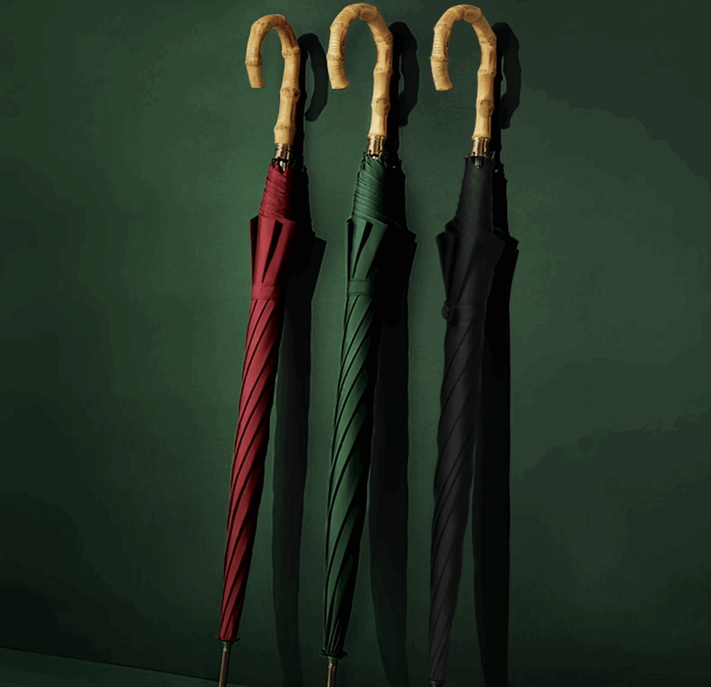 red umbrella green umbrella black umbrella at a green background
