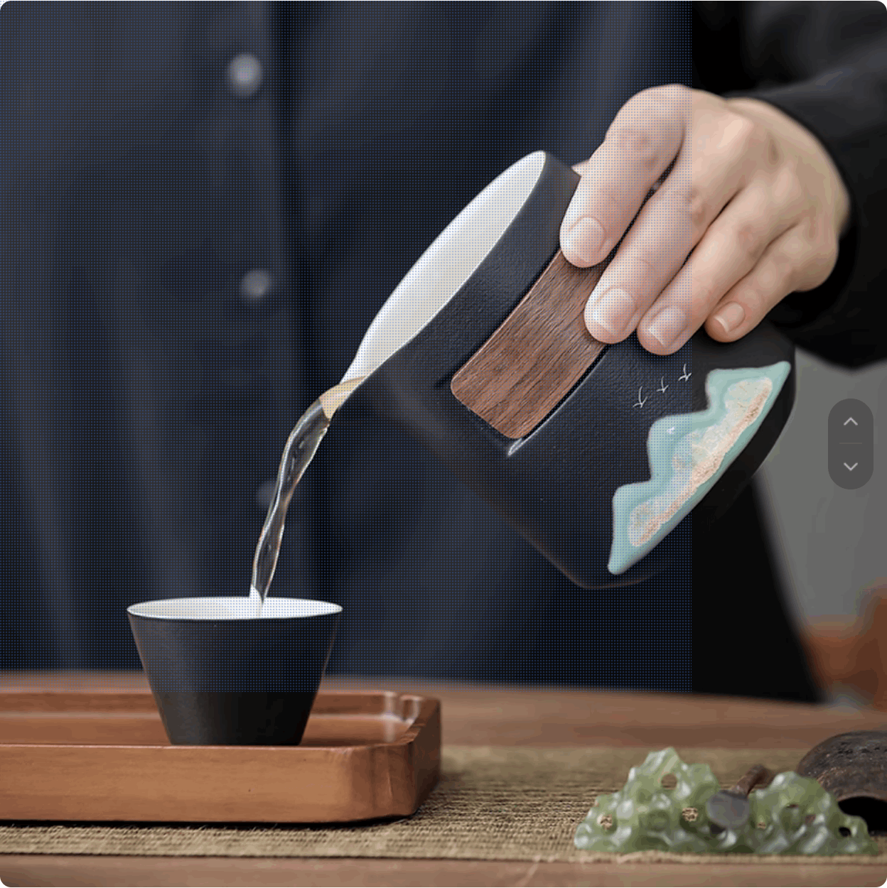 3-6 pouring tea from black teapot to black teacup