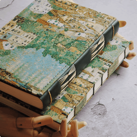 leather oil painting handbook on top of exposed oil painting handbook