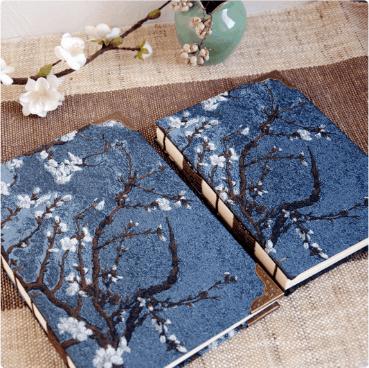 plum notebook different sizes on table