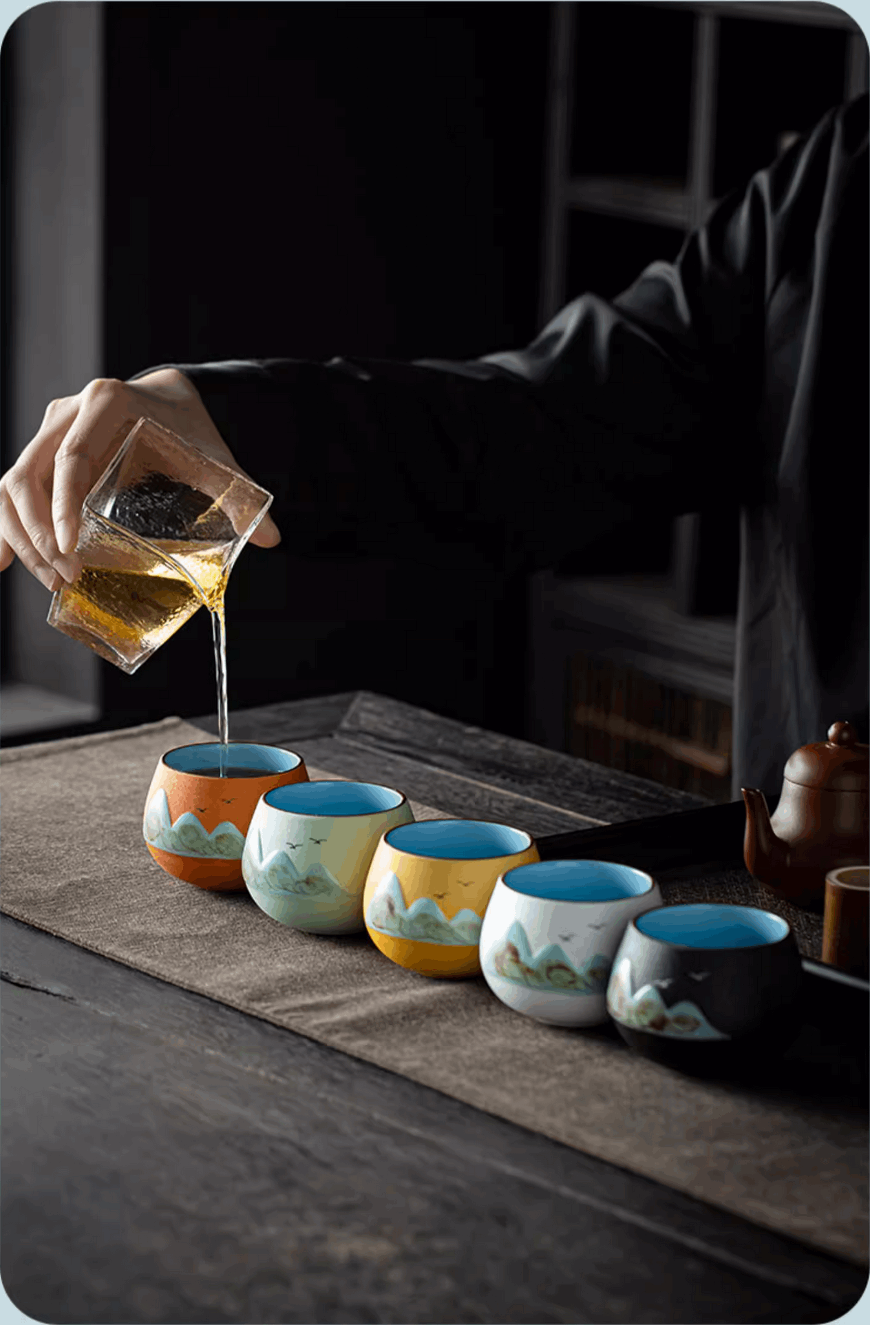 pouring tea into mountain valley teacup