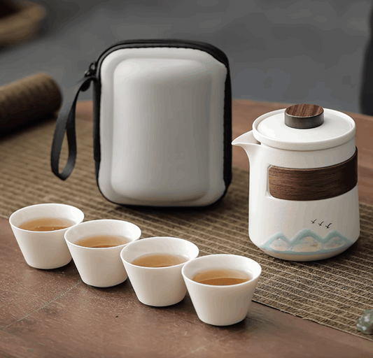 white teapot with white teacup and white casing