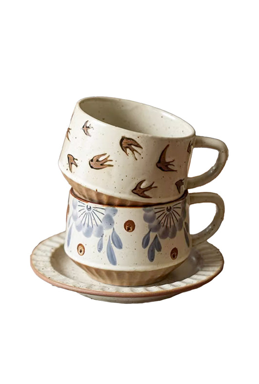brown design cup stacking on top of blue floral cup