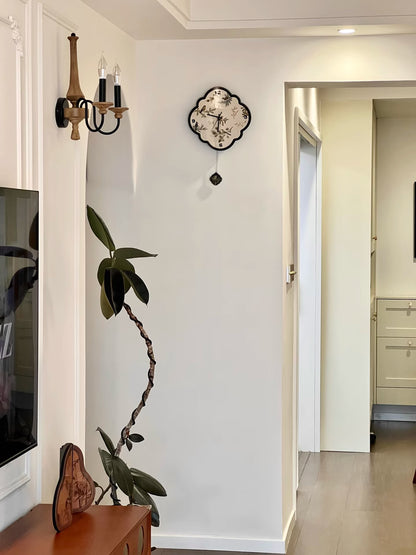 birds_and_leaf_black_and_white_clock on white wall beside television