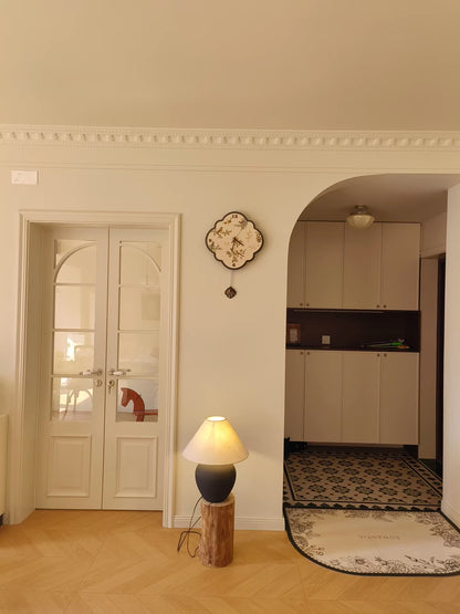 birds and leaf black and white clock placed beside door