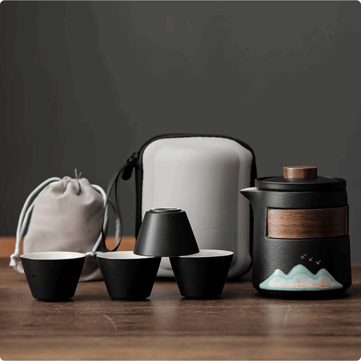 black teapot and black teacup with casing