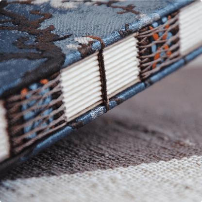 blue notebook with exposed side plum design