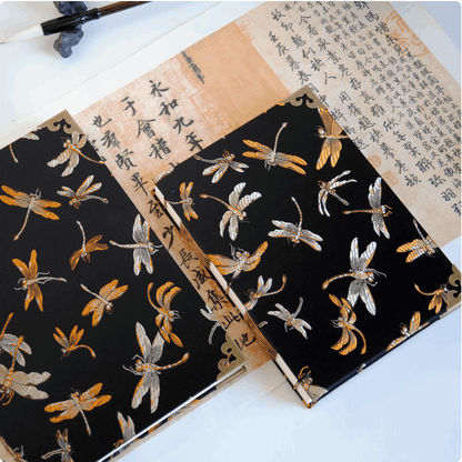 dragon fly notebook different size on table with many chinese words