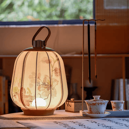 floral lamp lattern lit on table near window