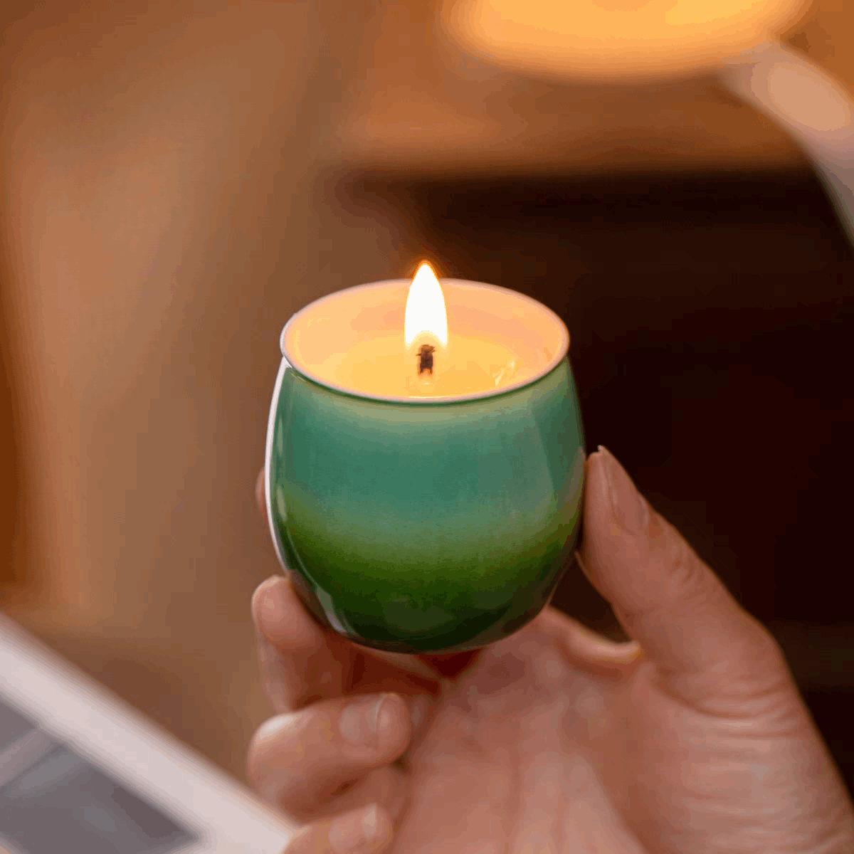 green candle lit upgreen candle lit up hold on hand