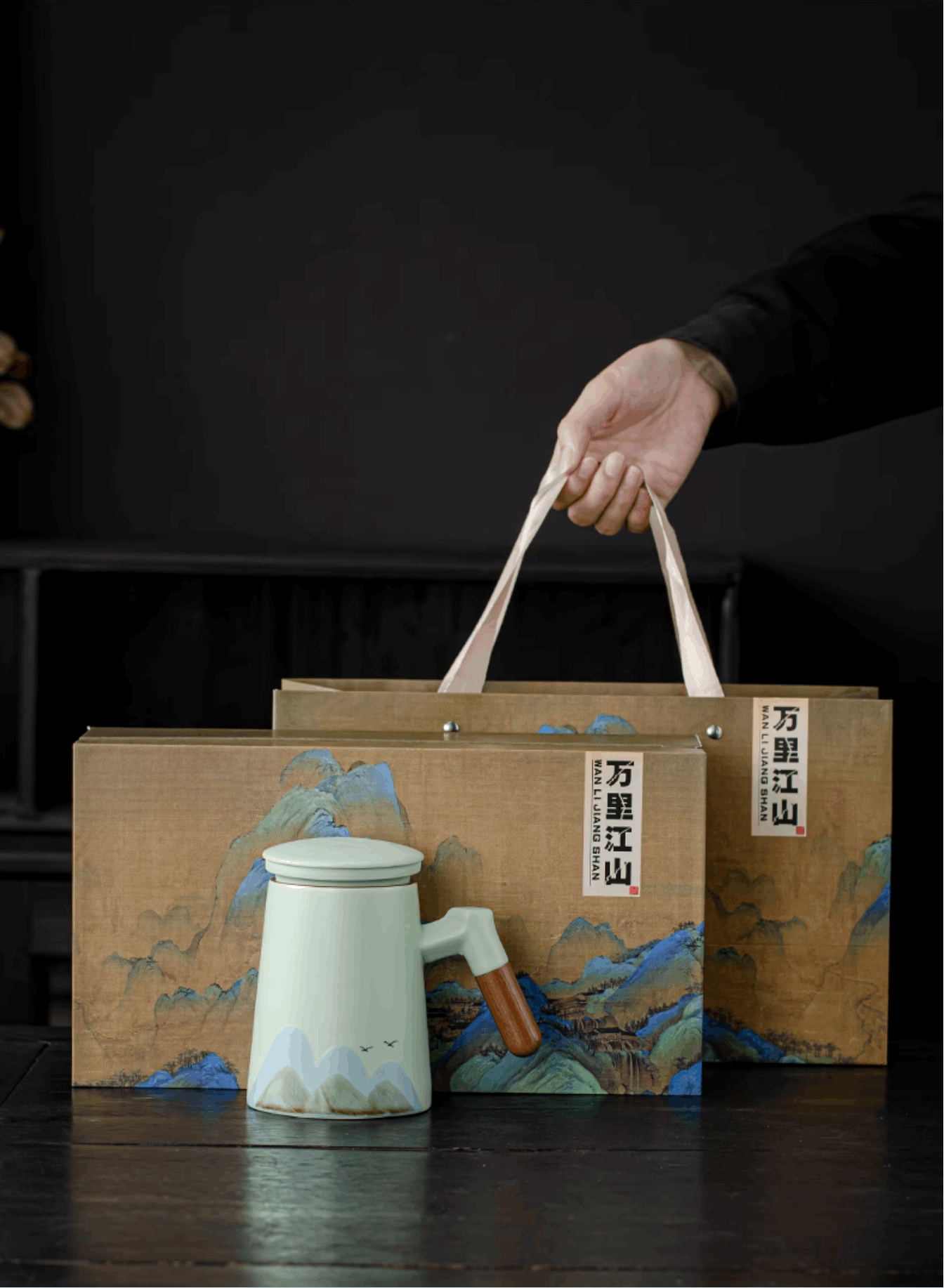holding gift tea pot gift box with tea pot at the front