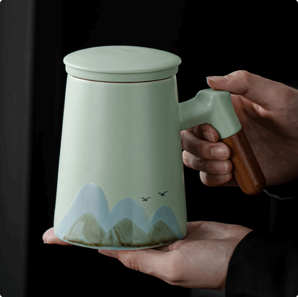 holding teapot with hand