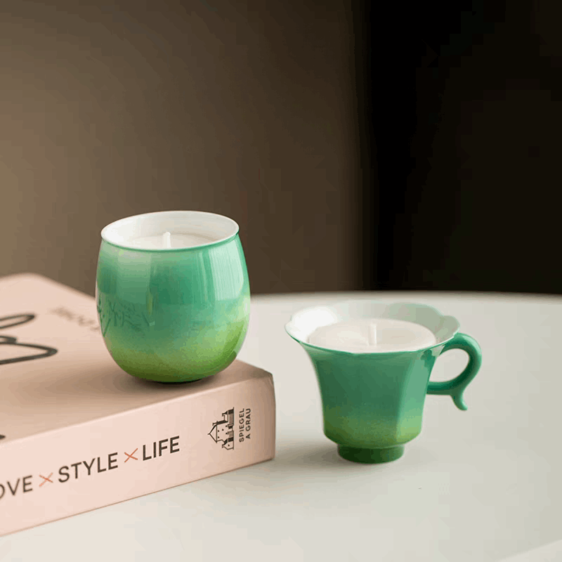 two green candle on white table
